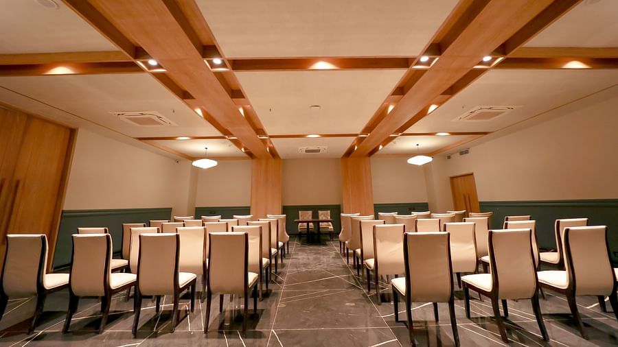 An image of several chairs and a centre table in a banquet hall - Pride Resort Ambaji